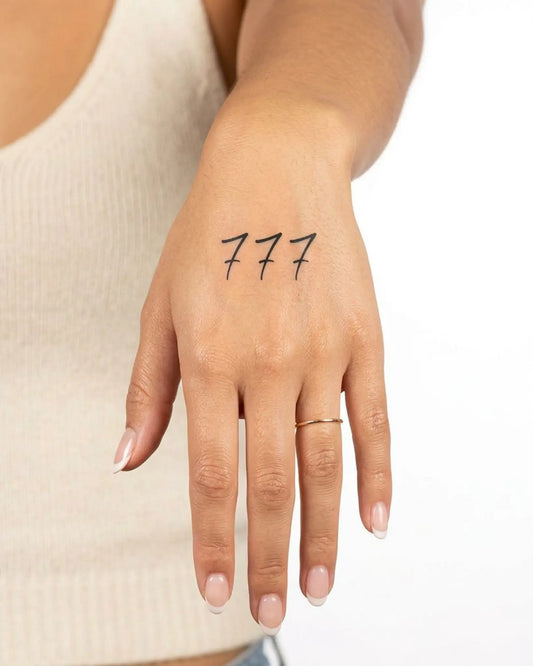 INKY Triple 7s semi-permanent tattoo applied on a woman – 2 x 2 in (4x4 cm) design, realistic ink look, lasts 10 days