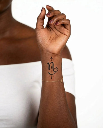 INKY Capricorn 2 semi-permanent tattoo applied on a woman – 2 x 2 in (4x4 cm) design, realistic ink look, lasts 10 days