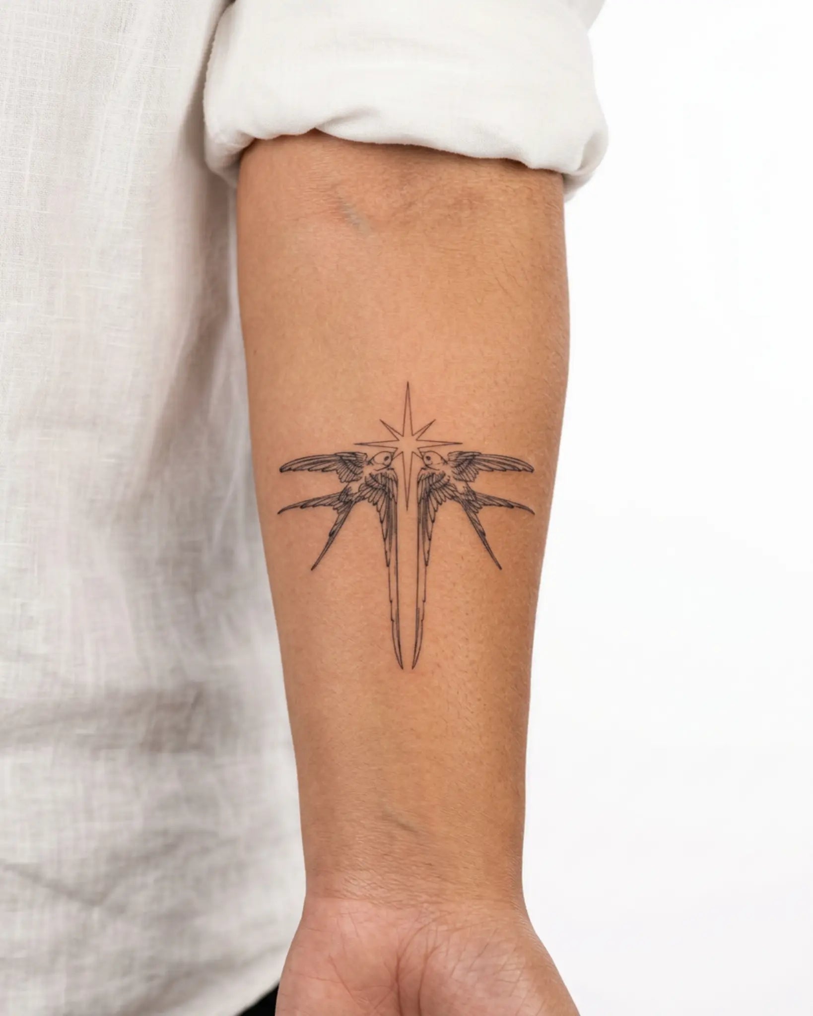 INKY Star Swallows semi-permanent tattoo applied on a woman – 3 x 3 in (7x7 cm) design, realistic ink look, lasts 10 days