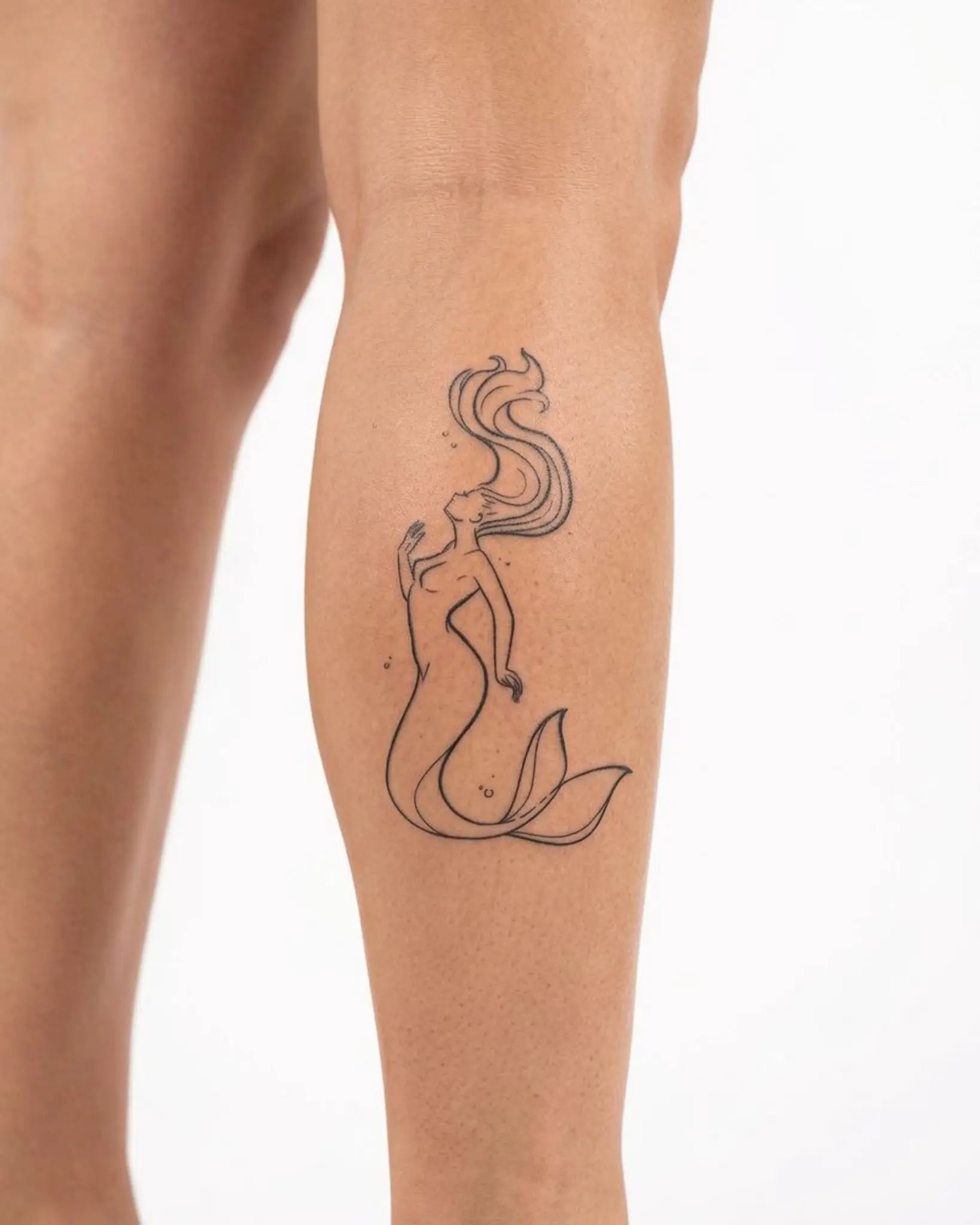 INKY Ocean Siren semi-permanent tattoo applied on a woman – 2 x 4 in (6x10 cm) design, realistic ink look, lasts 10 days