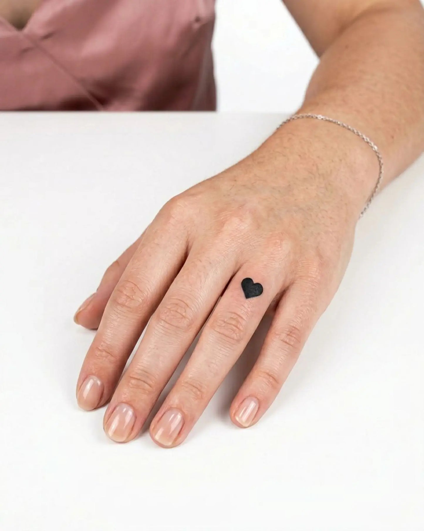 INKY Black Heart semi-permanent tattoo applied on a woman – 0.5 x 0.5 in (1x1 cm) design, realistic ink look, lasts 10 days
