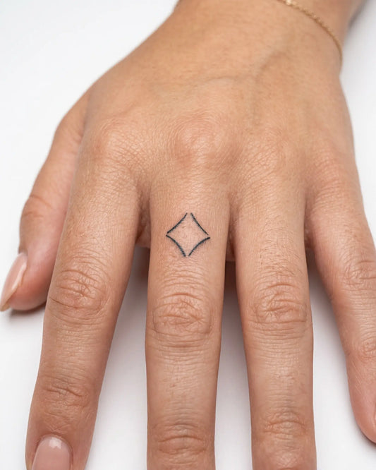 INKY Star Shard semi-permanent tattoo applied on a woman – 0.5 x 0.5 in (1x1 cm) design, realistic ink look, lasts 10 days