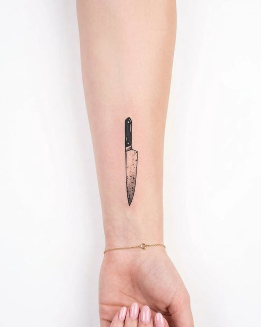 INKY Chef's Knife semi-permanent tattoo applied on a woman – 2 x 4 in (6x10 cm) design, realistic ink look, lasts 10 days