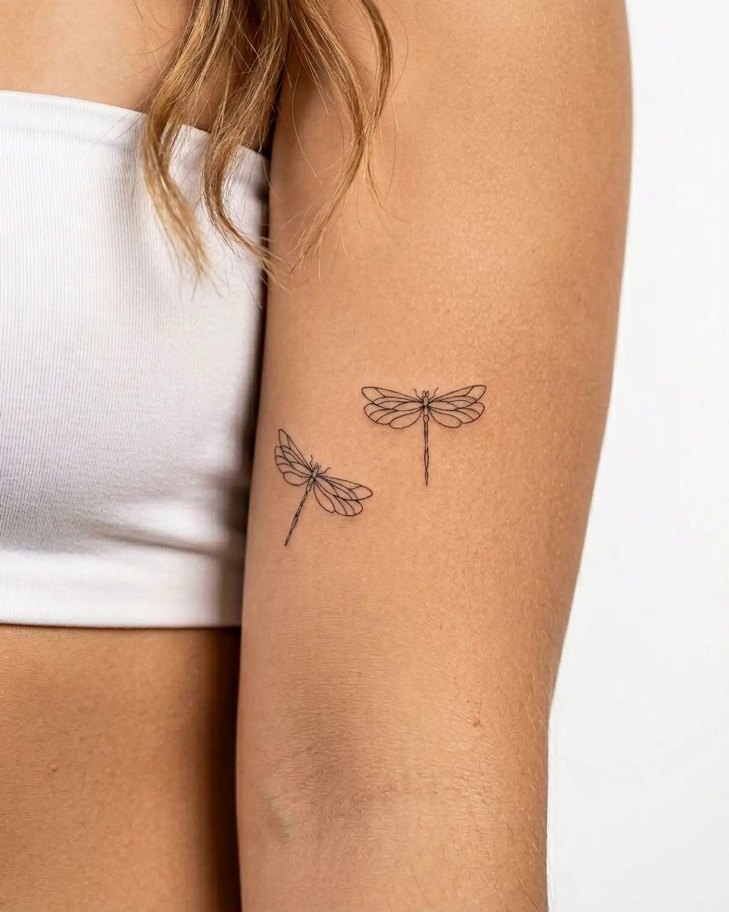 INKY Dragonfly Duo semi-permanent tattoo applied on a woman – 3 x 3 in (7x7 cm) design, realistic ink look, lasts 10 days