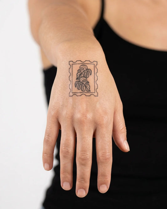INKY Monstera semi-permanent tattoo applied on a woman – 2 x 2 in (4x4 cm) design, realistic ink look, lasts 10 days