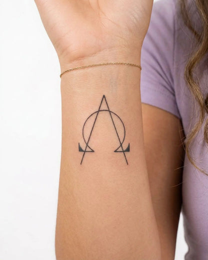 INKY AlphaOmega semi-permanent tattoo applied on a woman – 2 x 2 in (4x4 cm) design, realistic ink look, lasts 10 days