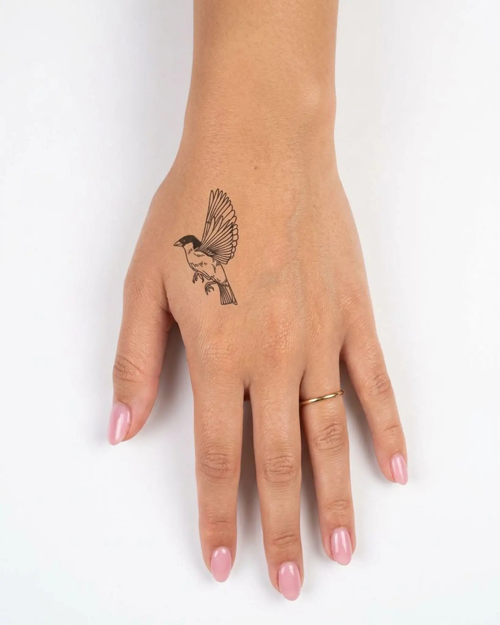 INKY Flying Bird semi-permanent tattoo applied on a woman – 2 x 2 in (4x4 cm) design, realistic ink look, lasts 10 days