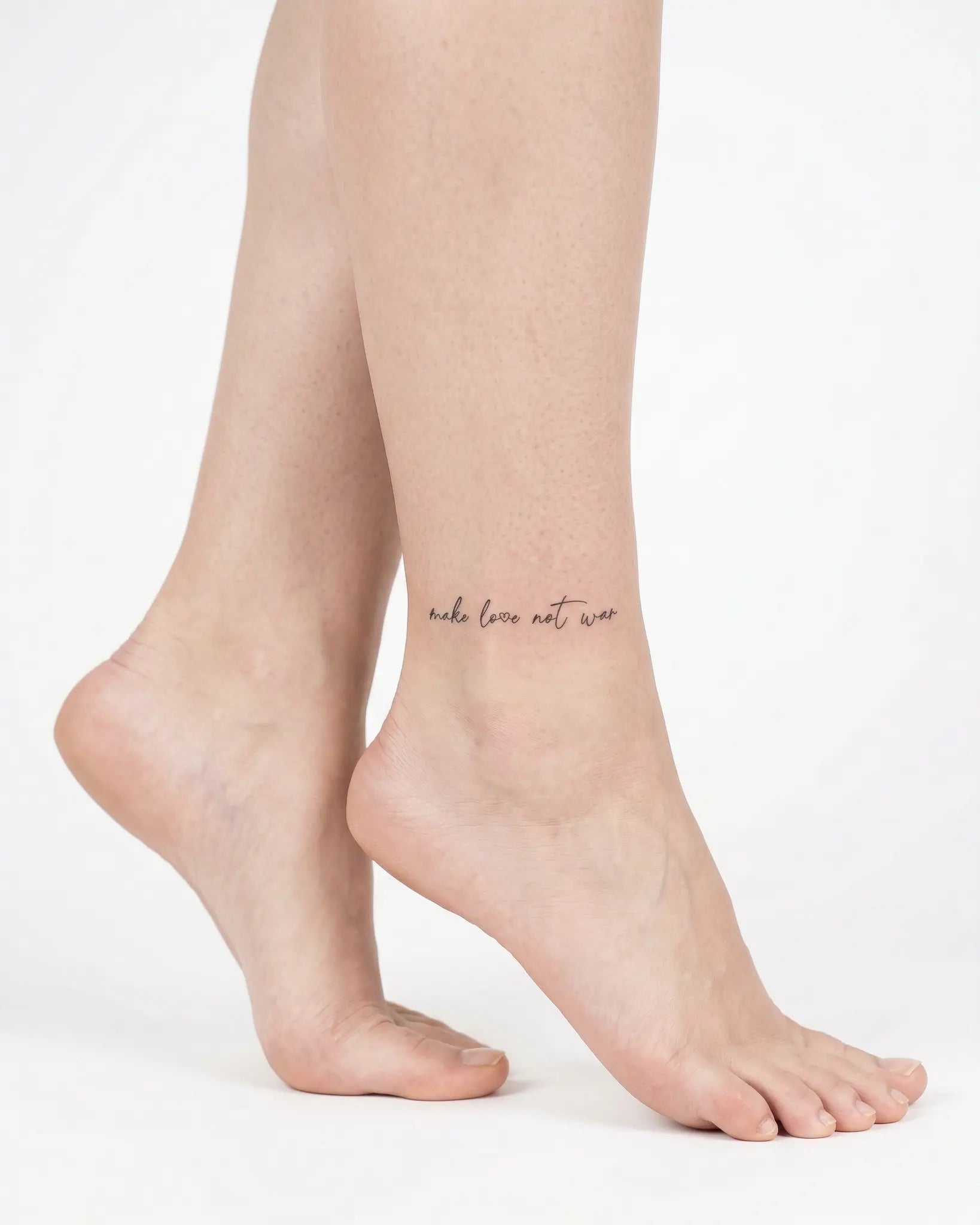 INKY Love Not War 2 semi-permanent tattoo applied on a woman – 2 x 2 in (4x4 cm) design, realistic ink look, lasts 10 days