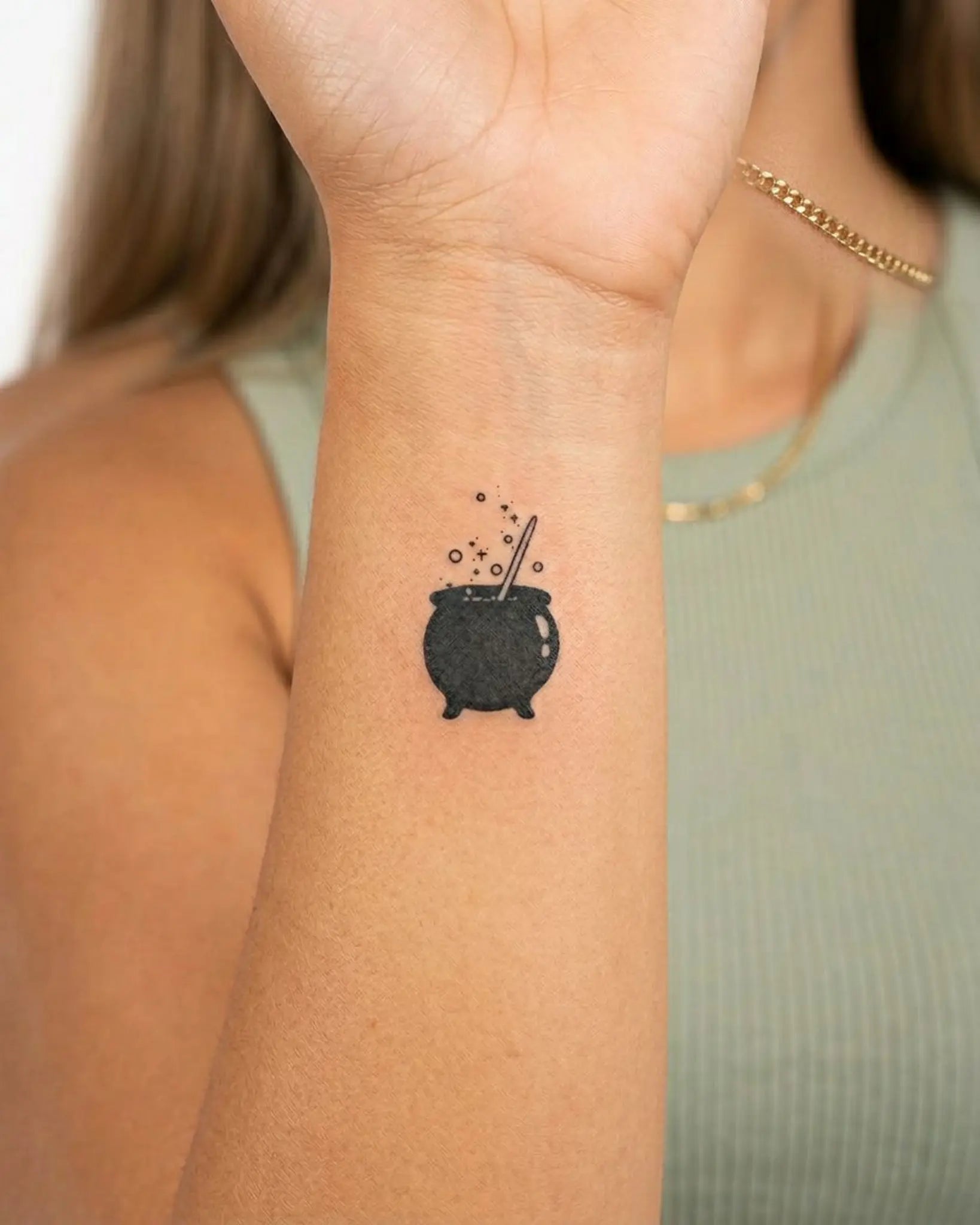 INKY Cauldron semi-permanent tattoo applied on a woman – 0.5 x 0.5 in (1x1 cm) design, realistic ink look, lasts 10 days