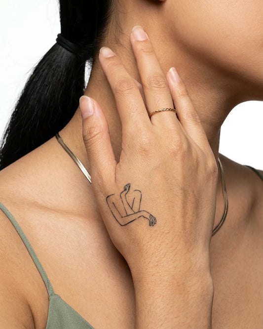 INKY Body Lines semi-permanent tattoo applied on a woman – 2 x 2 in (4x4 cm) design, realistic ink look, lasts 10 days