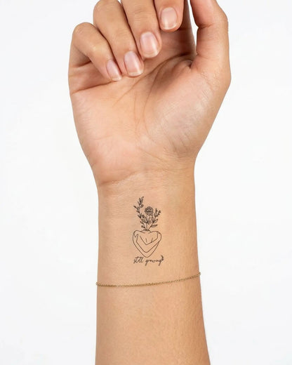 INKY Still Growing 2 semi-permanent tattoo applied on a woman – 2 x 2 in (4x4 cm) design, realistic ink look, lasts 10 days