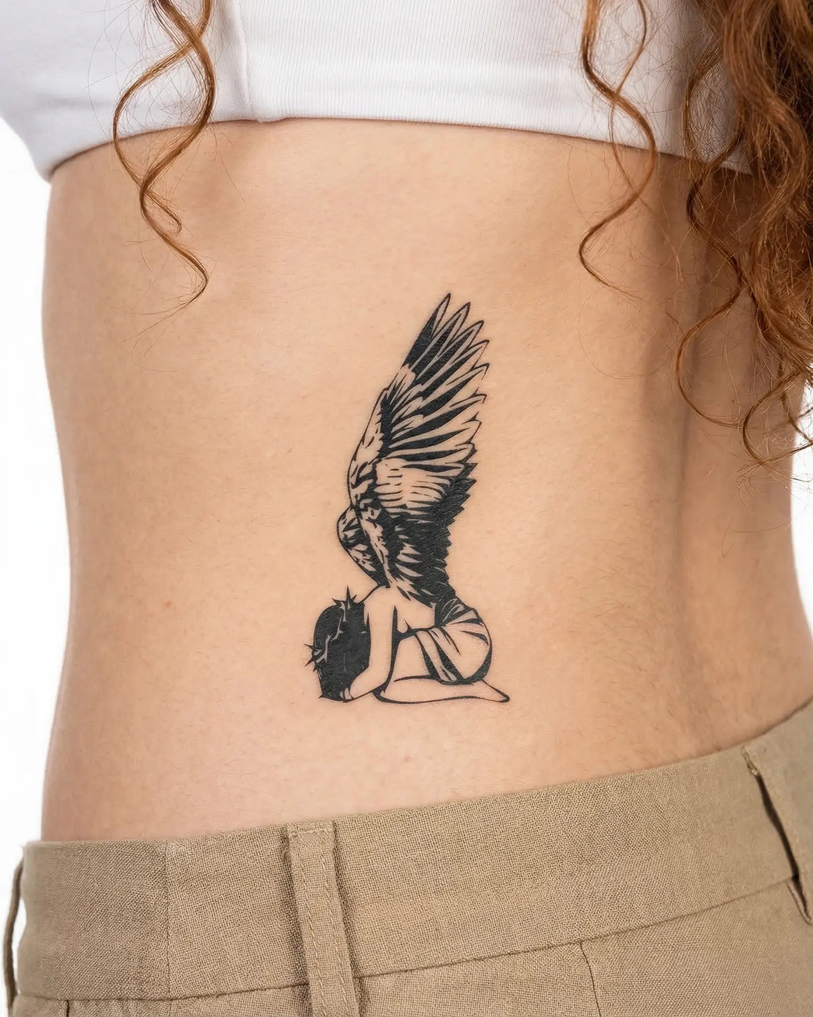 INKY Fallen Angel semi-permanent tattoo applied on a woman – 2 x 4 in (6x10 cm) design, realistic ink look, lasts 10 days