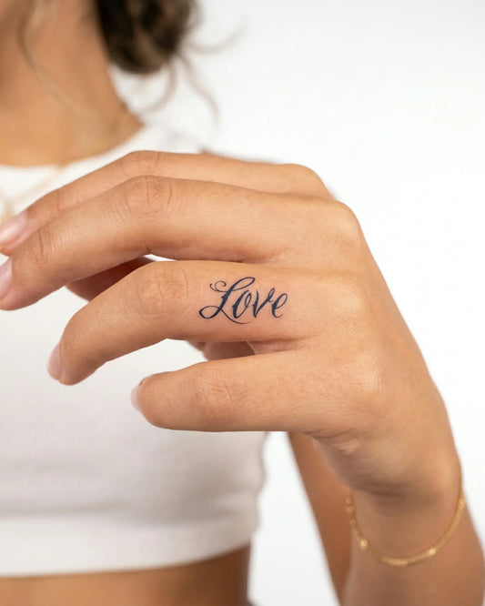 INKY Love Script semi-permanent tattoo applied on a woman – 0.5 x 0.5 in (1x1 cm) design, realistic ink look, lasts 10 days