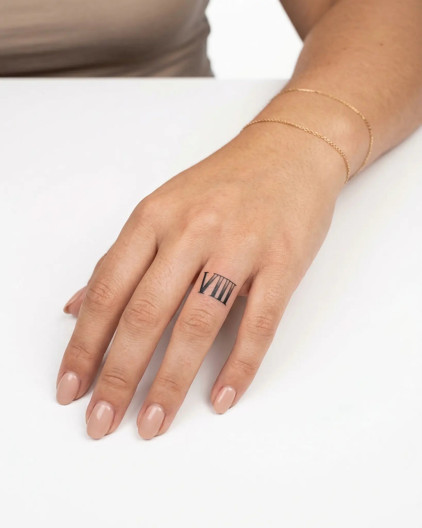 INKY Roman 8 semi-permanent tattoo applied on a woman – 0.5 x 0.5 in (1x1 cm) design, realistic ink look, lasts 10 days