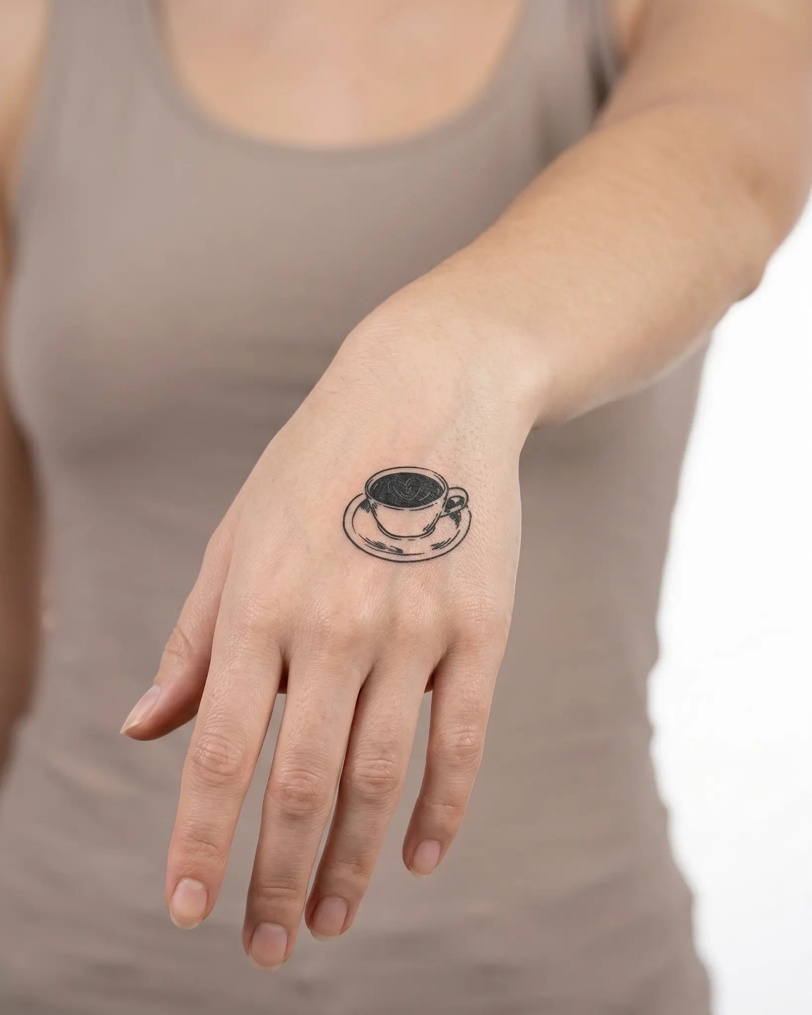 INKY Latte Love semi-permanent tattoo applied on a woman – 2 x 2 in (4x4 cm) design, realistic ink look, lasts 10 days