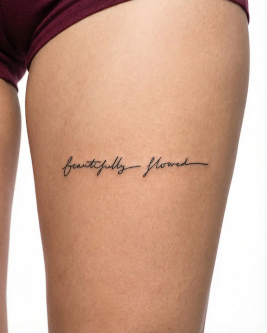 INKY Flowed Script semi-permanent tattoo applied on a woman – 2 x 4 in (6x10 cm) design, realistic ink look, lasts 10 days