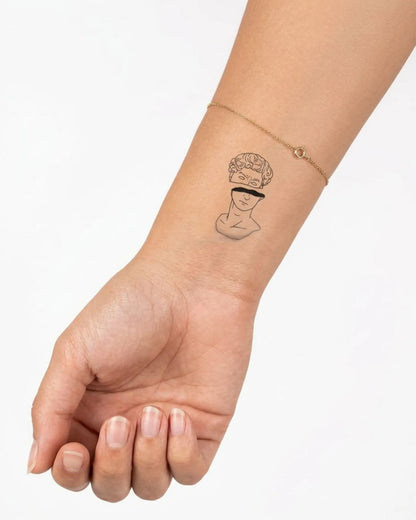 INKY Split Statue 2 semi-permanent tattoo applied on a woman – 2 x 2 in (4x4 cm) design, realistic ink look, lasts 10 days