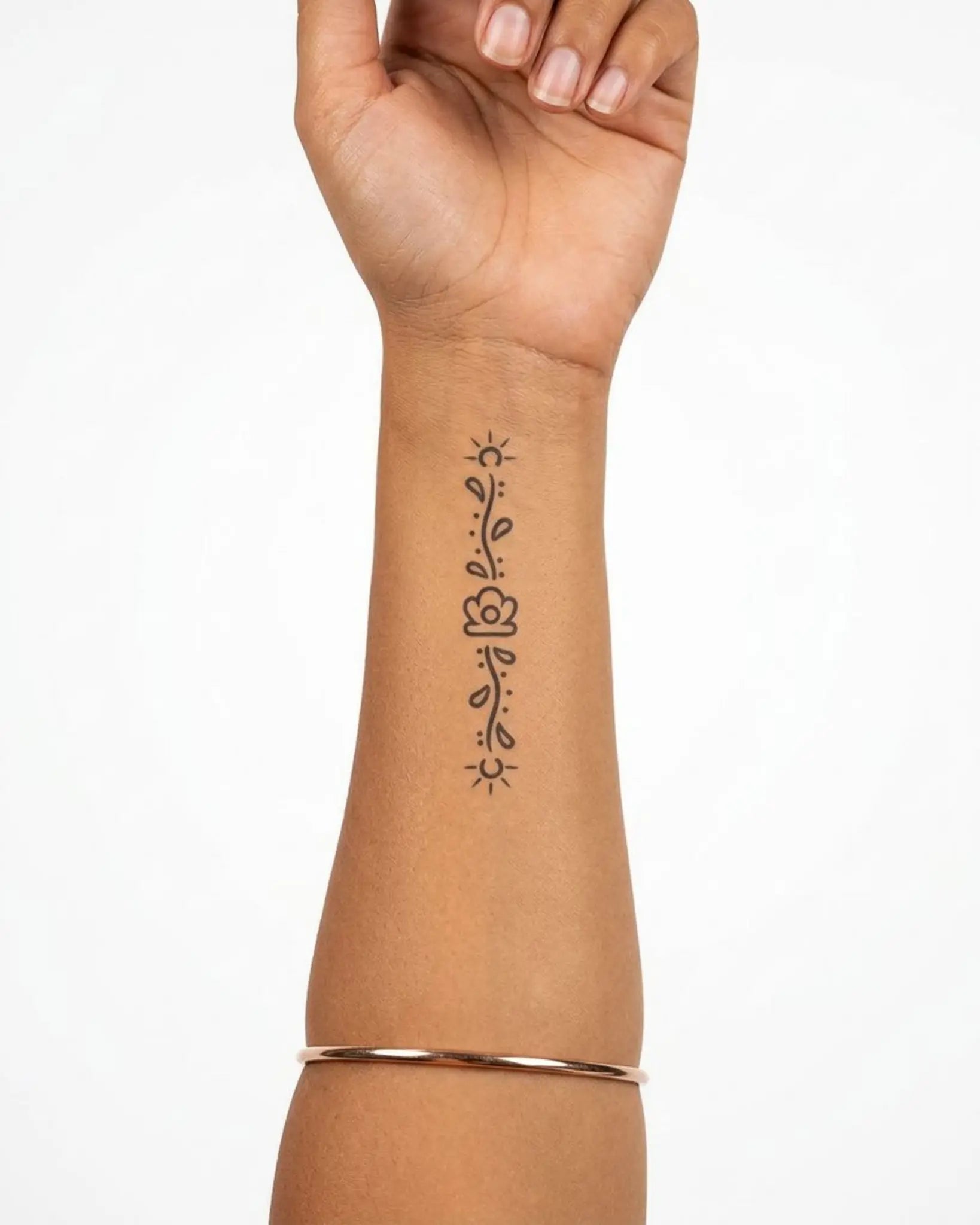 INKY Sun & Vine semi-permanent tattoo applied on a woman – 2 x 4 in (6x10 cm) design, realistic ink look, lasts 10 days