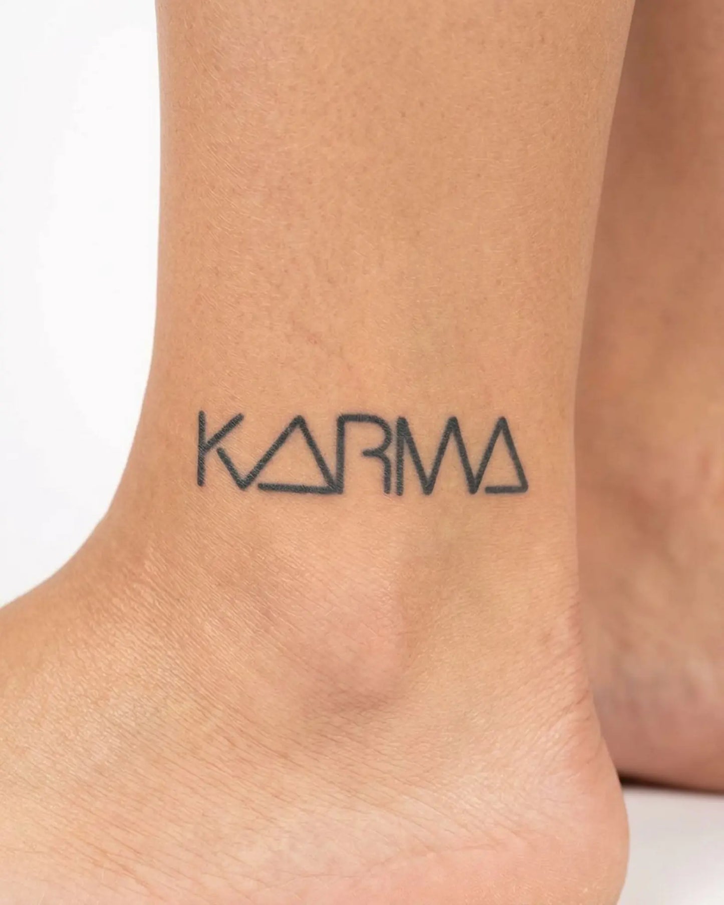 INKY KARMA semi-permanent tattoo applied on a woman – 2 x 2 in (4x4 cm) design, realistic ink look, lasts 10 days