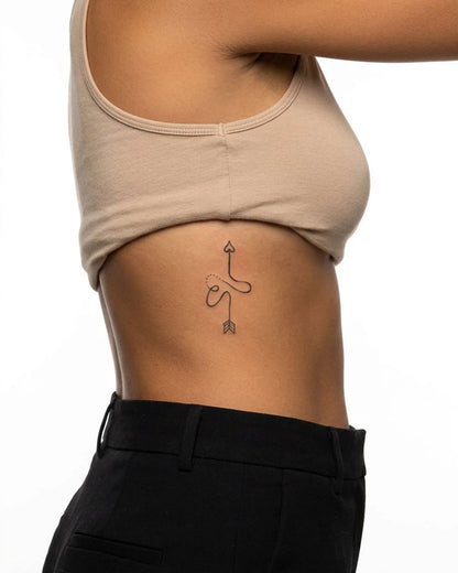 INKY S Heart Bow semi-permanent tattoo applied on a woman – 2 x 4 in (6x10 cm) design, realistic ink look, lasts 10 days