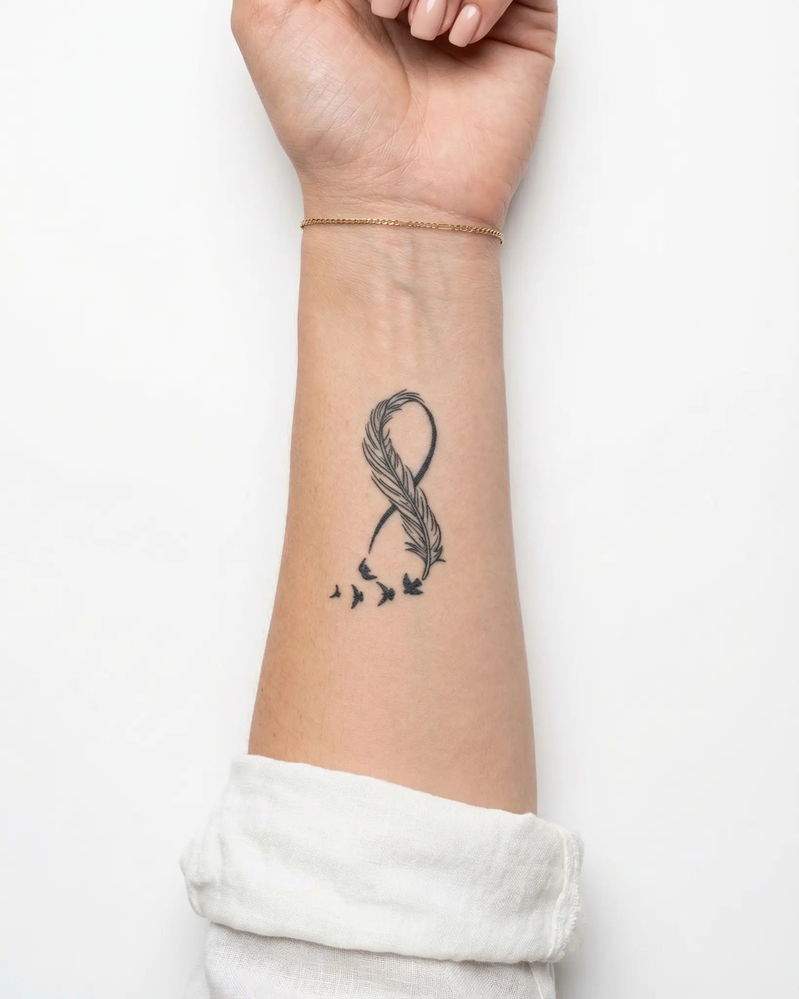 INKY Feather Fligh semi-permanent tattoo applied on a woman – 2 x 4 in (6x10 cm) design, realistic ink look, lasts 10 days