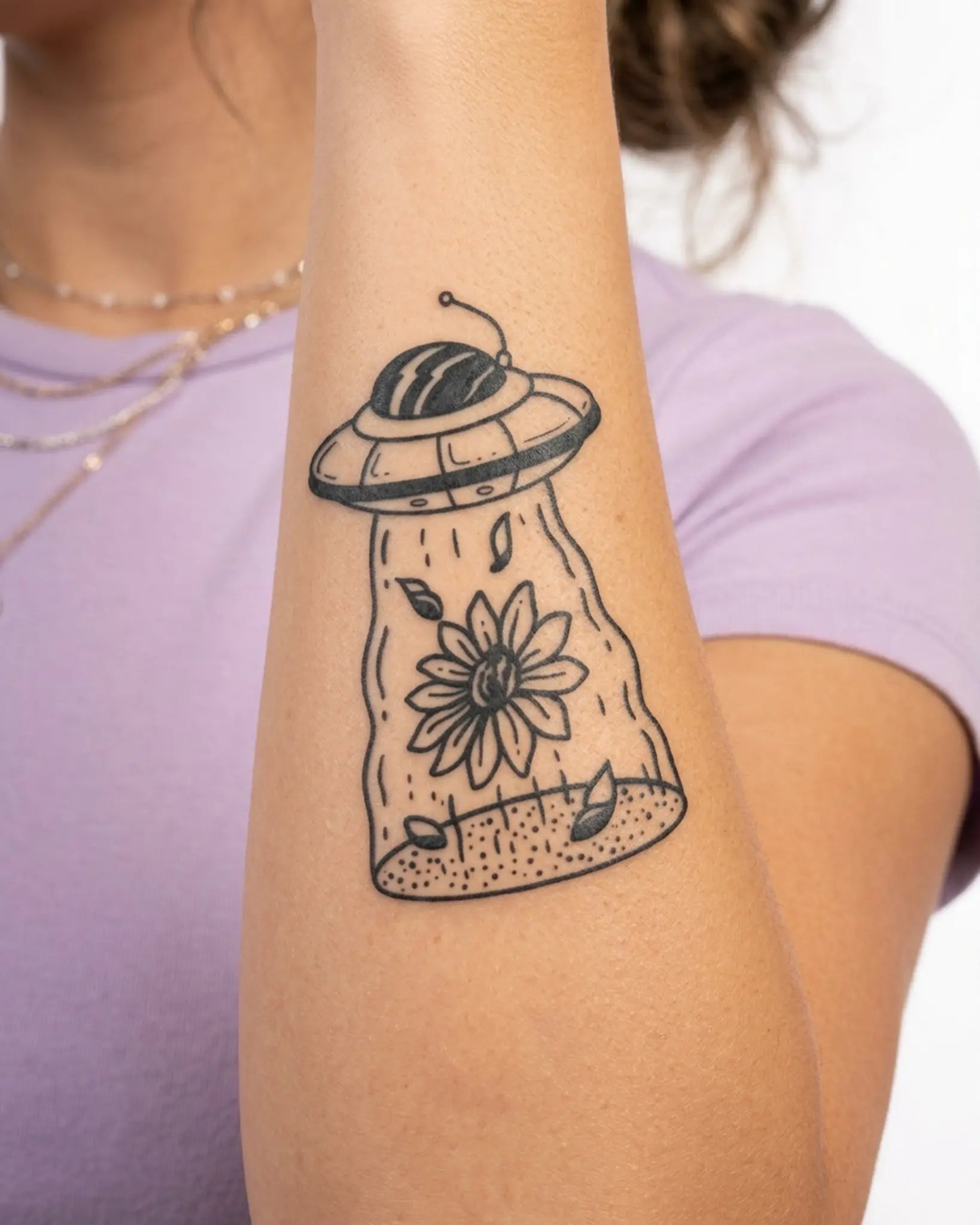 INKY UFO Flower 2 semi-permanent tattoo applied on a woman – 2 x 4 in (6x10 cm) design, realistic ink look, lasts 10 days