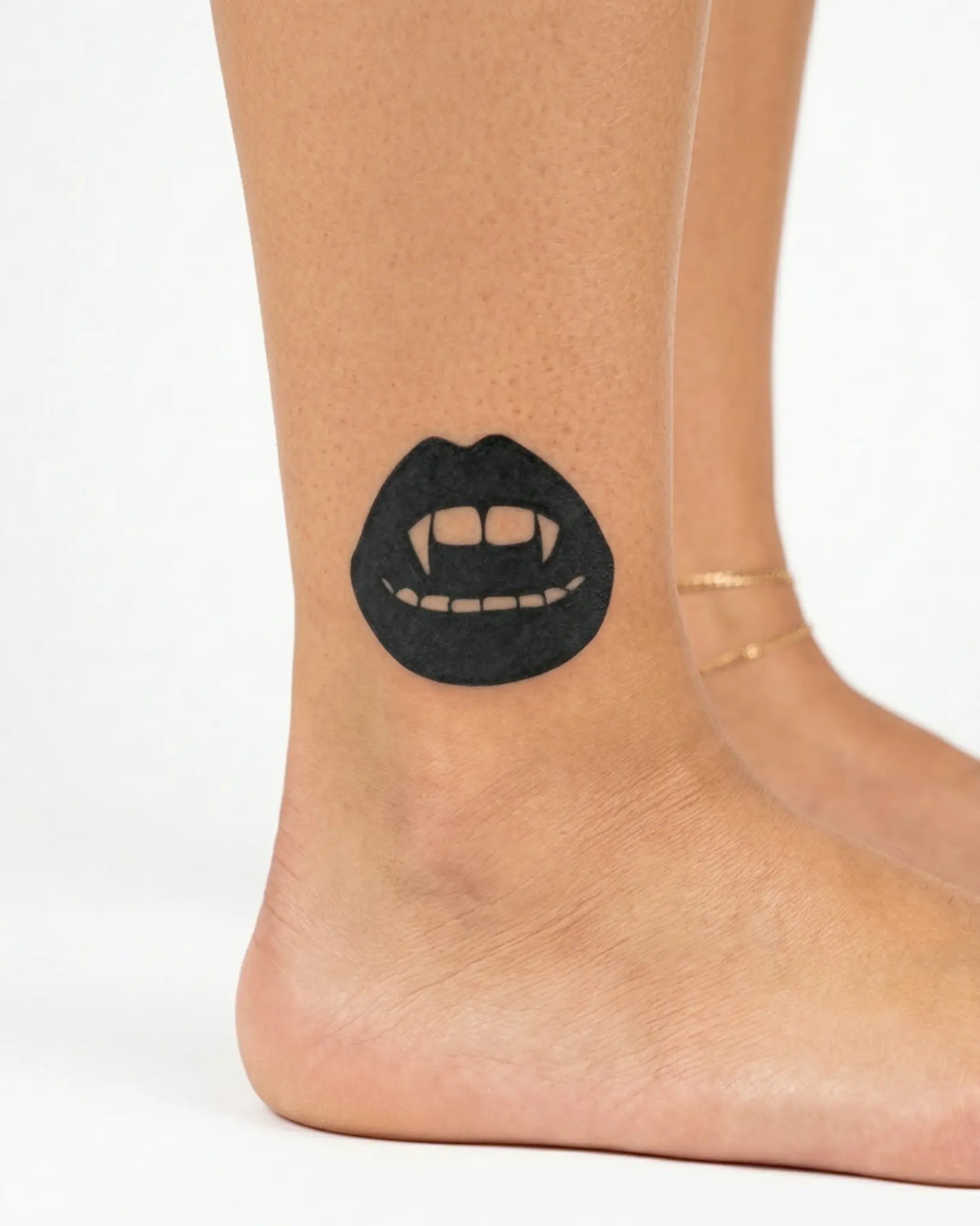 INKY Vampire Lips semi-permanent tattoo applied on a woman – 2 x 2 in (4x4 cm) design, realistic ink look, lasts 10 days