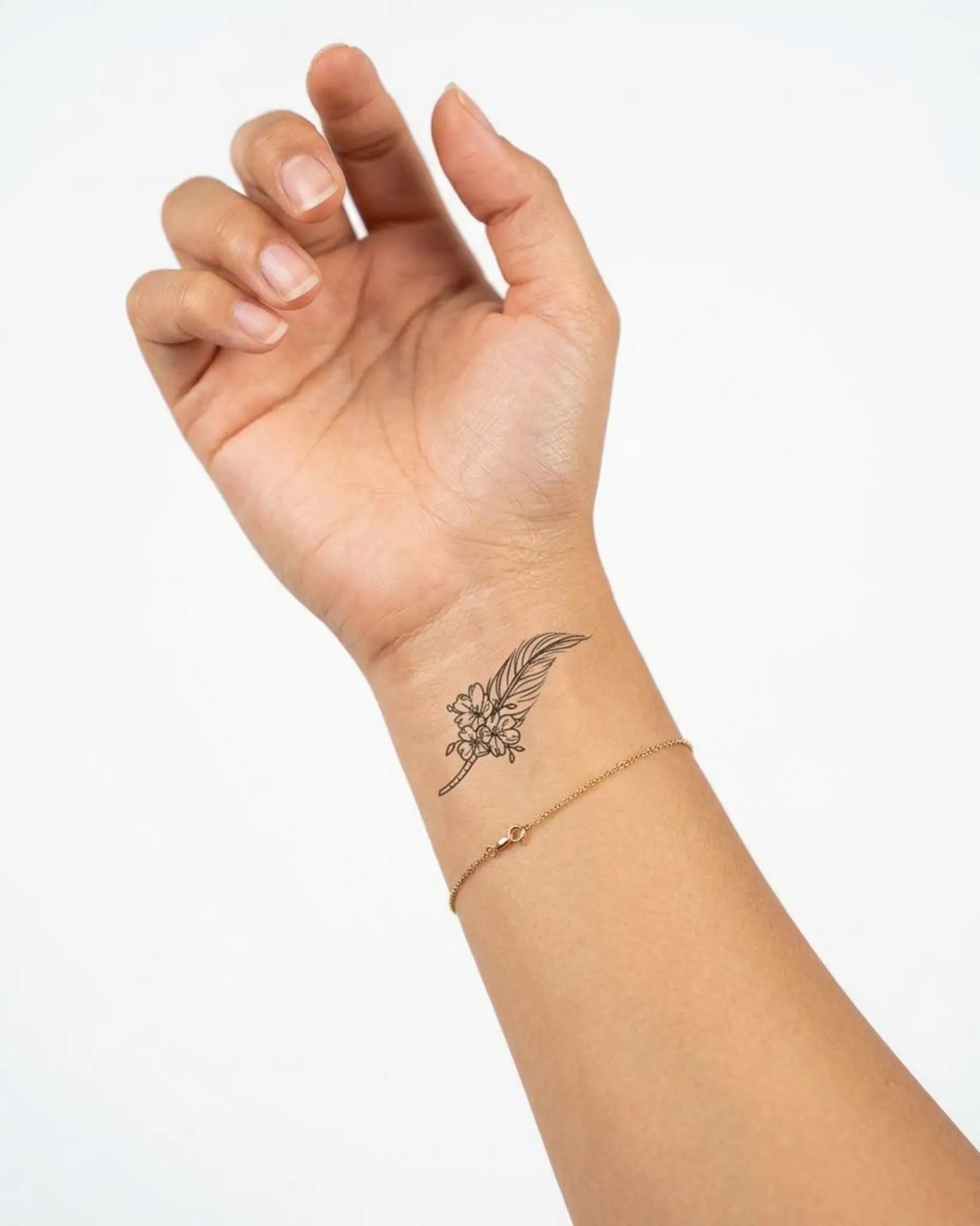 INKY Feather & Flo semi-permanent tattoo applied on a woman – 2 x 2 in (4x4 cm) design, realistic ink look, lasts 10 days
