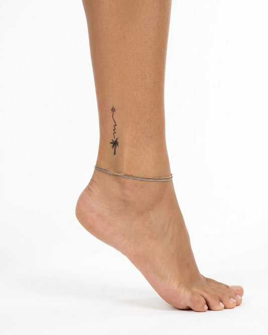 INKY Sun & Palm semi-permanent tattoo applied on a woman – 2 x 2 in (4x4 cm) design, realistic ink look, lasts 10 days