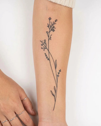 INKY Meadow Stem 2 semi-permanent tattoo applied on a woman – 4 x 7 in (10x17 cm) design, realistic ink look, lasts 10 days