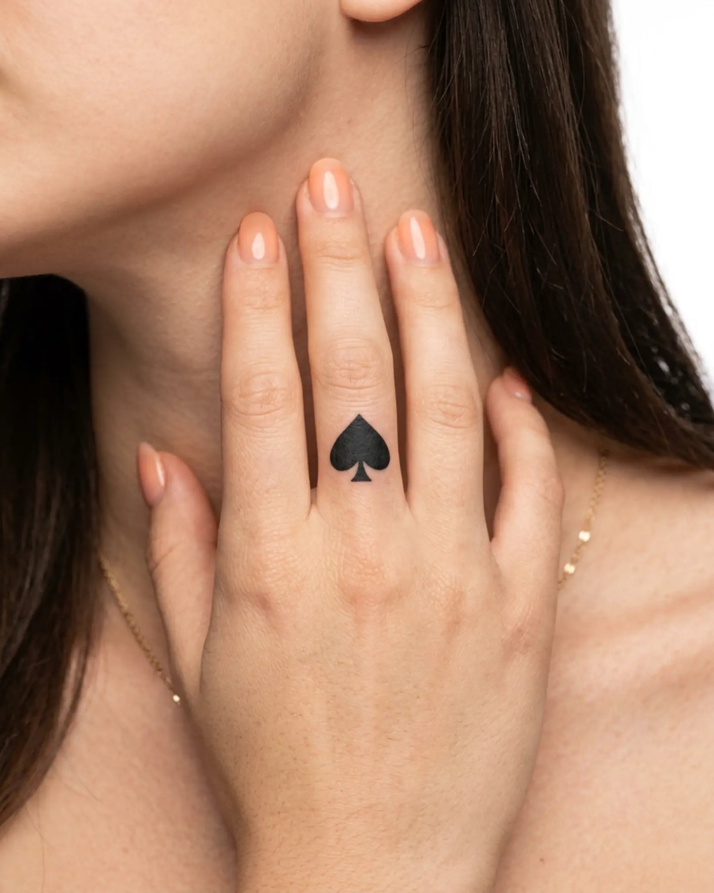 INKY Ace Spade semi-permanent tattoo applied on a woman – 0.5 x 0.5 in (1x1 cm) design, realistic ink look, lasts 10 days