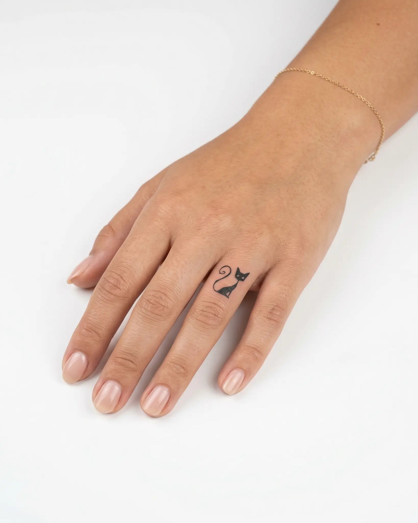 INKY Abstract Cat semi-permanent tattoo applied on a woman – 0.5 x 0.5 in (1x1 cm) design, realistic ink look, lasts 10 days