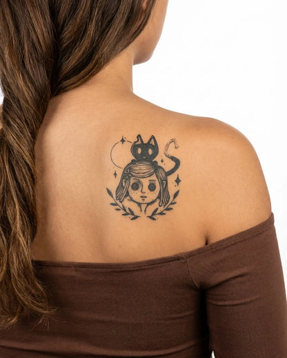INKY Button Eyes semi-permanent tattoo applied on a woman – 3 x 3 in (7x7 cm) design, realistic ink look, lasts 10 days