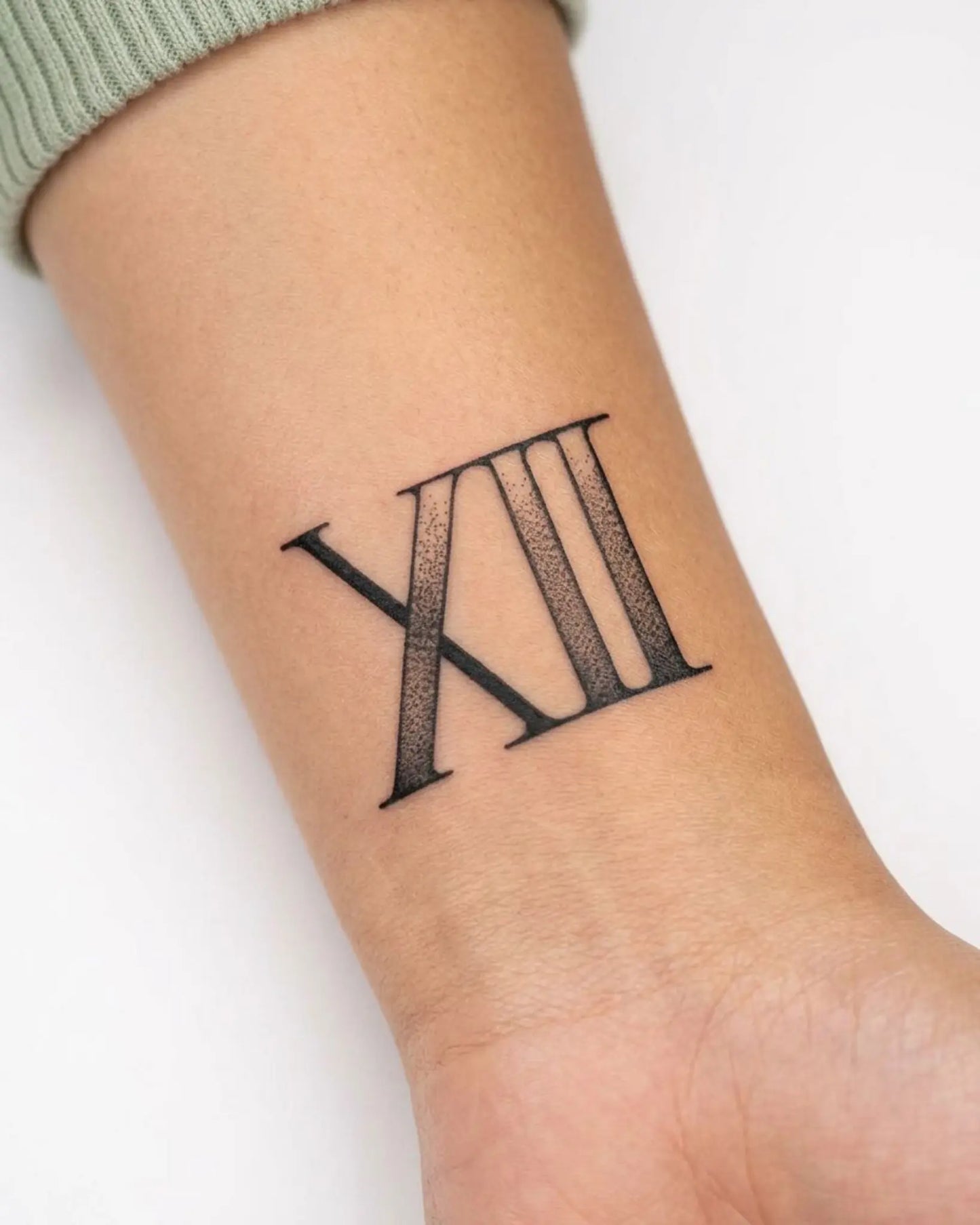 INKY Roman 12 semi-permanent tattoo applied on a woman – 2 x 2 in (4x4 cm) design, realistic ink look, lasts 10 days