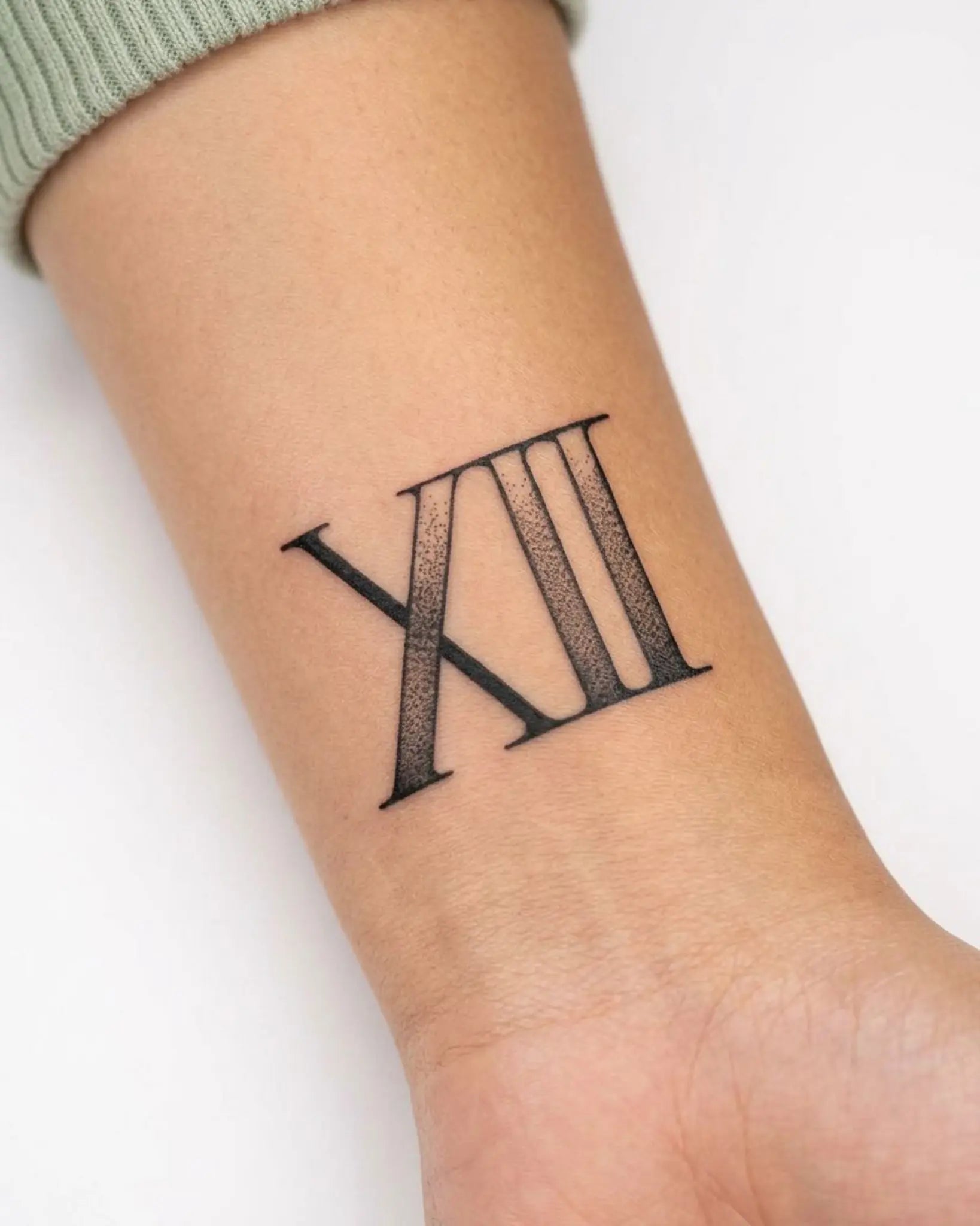 INKY Roman 12 semi-permanent tattoo applied on a woman – 2 x 2 in (4x4 cm) design, realistic ink look, lasts 10 days