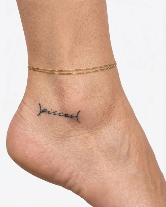 INKY Pisces Script semi-permanent tattoo applied on a woman – 2 x 2 in (4x4 cm) design, realistic ink look, lasts 10 days