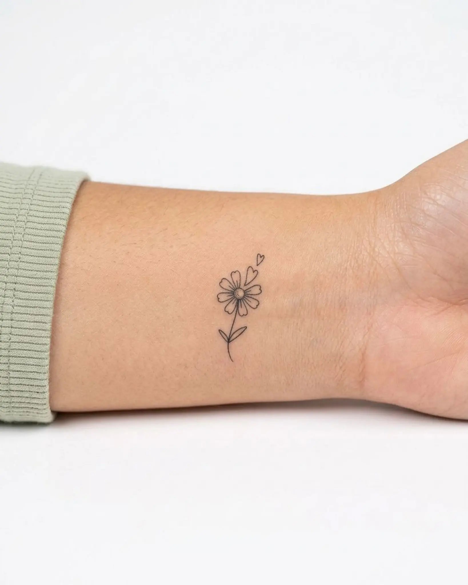 INKY Daisy Love semi-permanent tattoo applied on a woman – 0.5 x 0.5 in (1x1 cm) design, realistic ink look, lasts 10 days