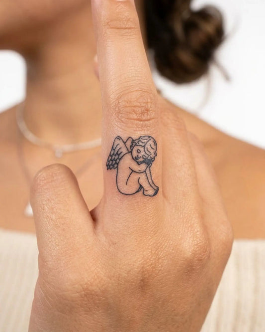 INKY Sweet Cherub semi-permanent tattoo applied on a woman – 0.5 x 0.5 in (1x1 cm) design, realistic ink look, lasts 10 days