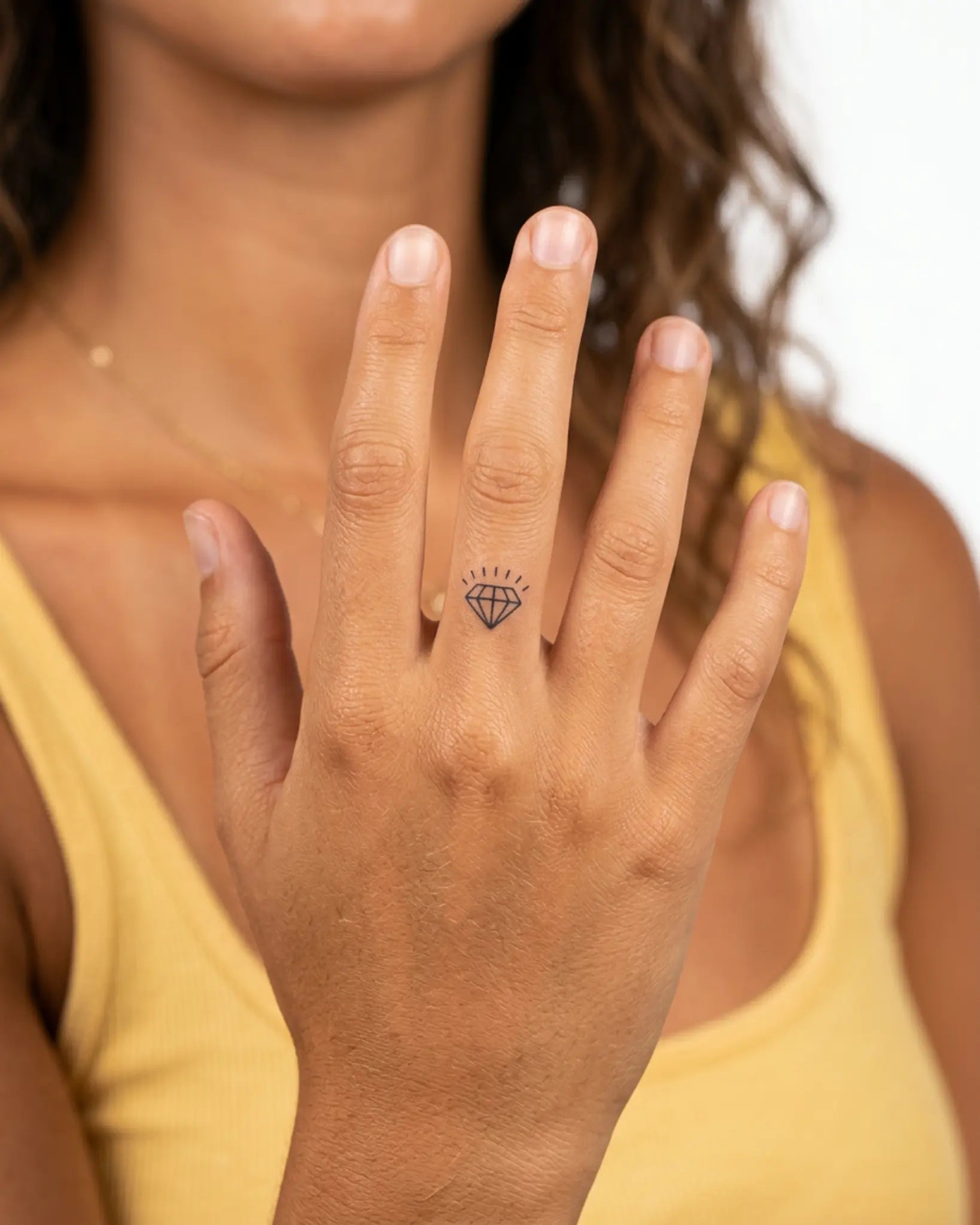 INKY Gem Glow semi-permanent tattoo applied on a woman – 0.5 x 0.5 in (1x1 cm) design, realistic ink look, lasts 10 days