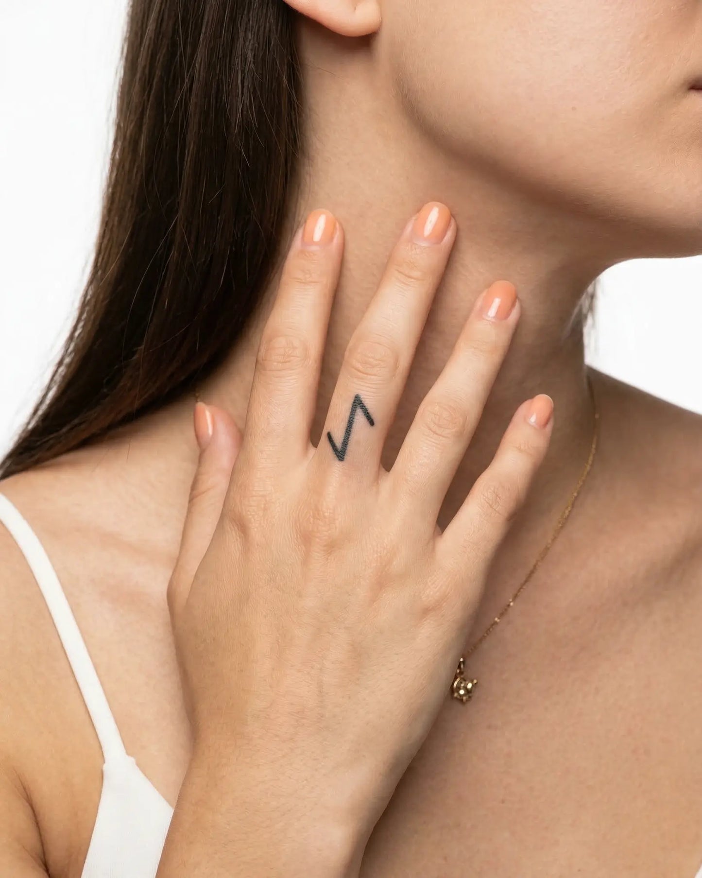 INKY Algiz Rune semi-permanent tattoo applied on a woman – 0.5 x 0.5 in (1x1 cm) design, realistic ink look, lasts 10 days