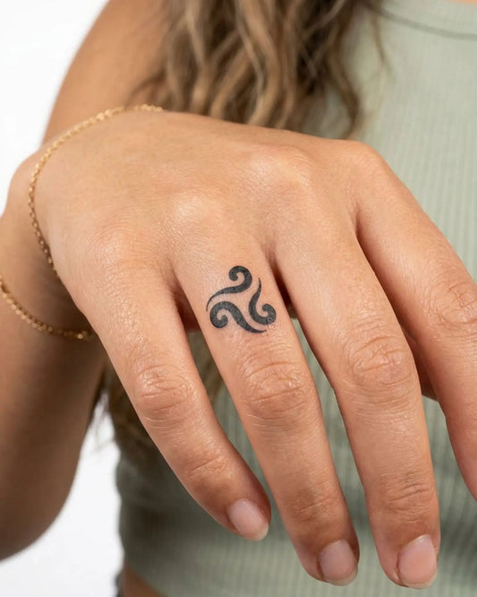 INKY Triskele semi-permanent tattoo applied on a woman – 0.5 x 0.5 in (1x1 cm) design, realistic ink look, lasts 10 days
