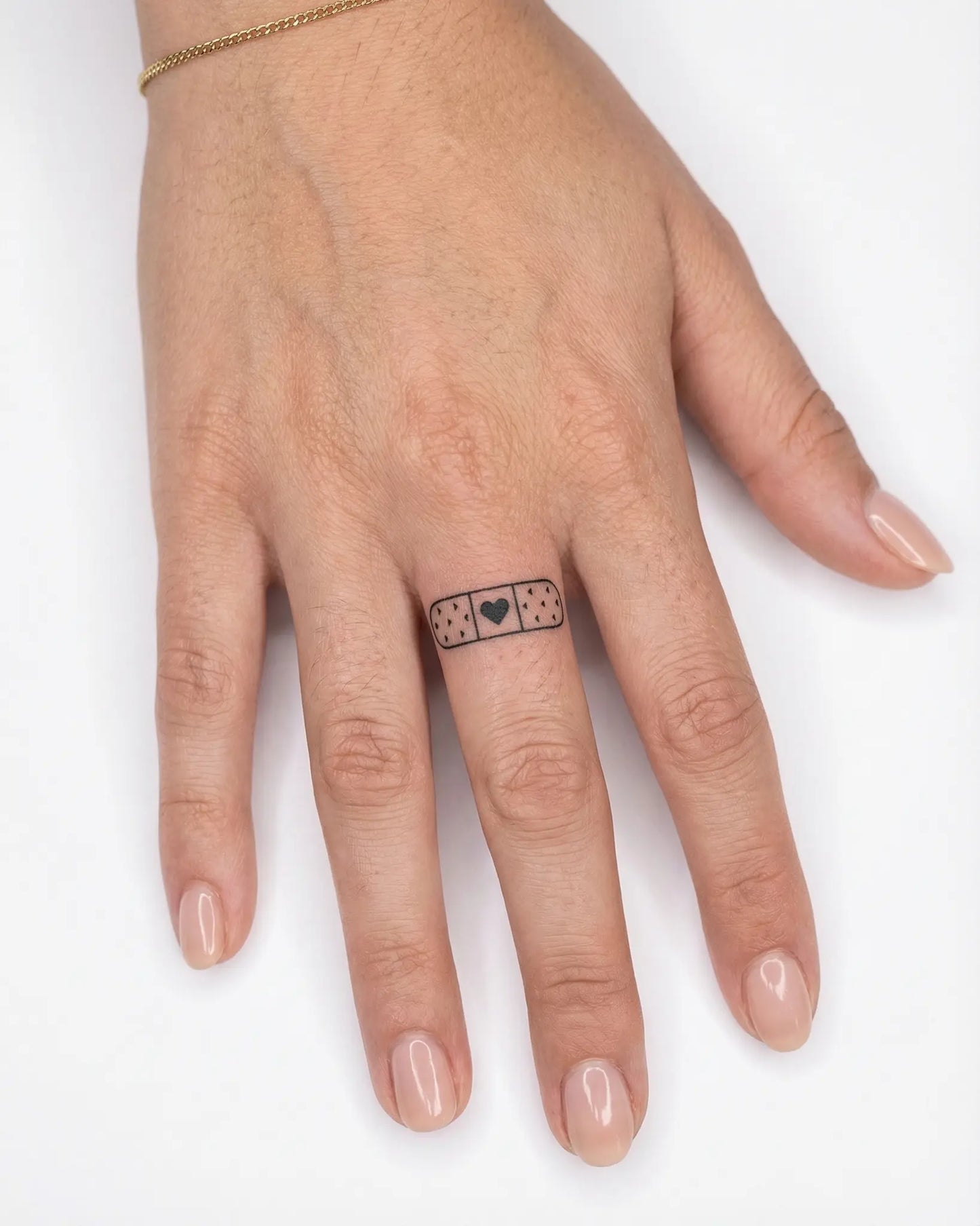INKY Heart Aid 2 semi-permanent tattoo applied on a woman – 0.5 x 0.5 in (1x1 cm) design, realistic ink look, lasts 10 days