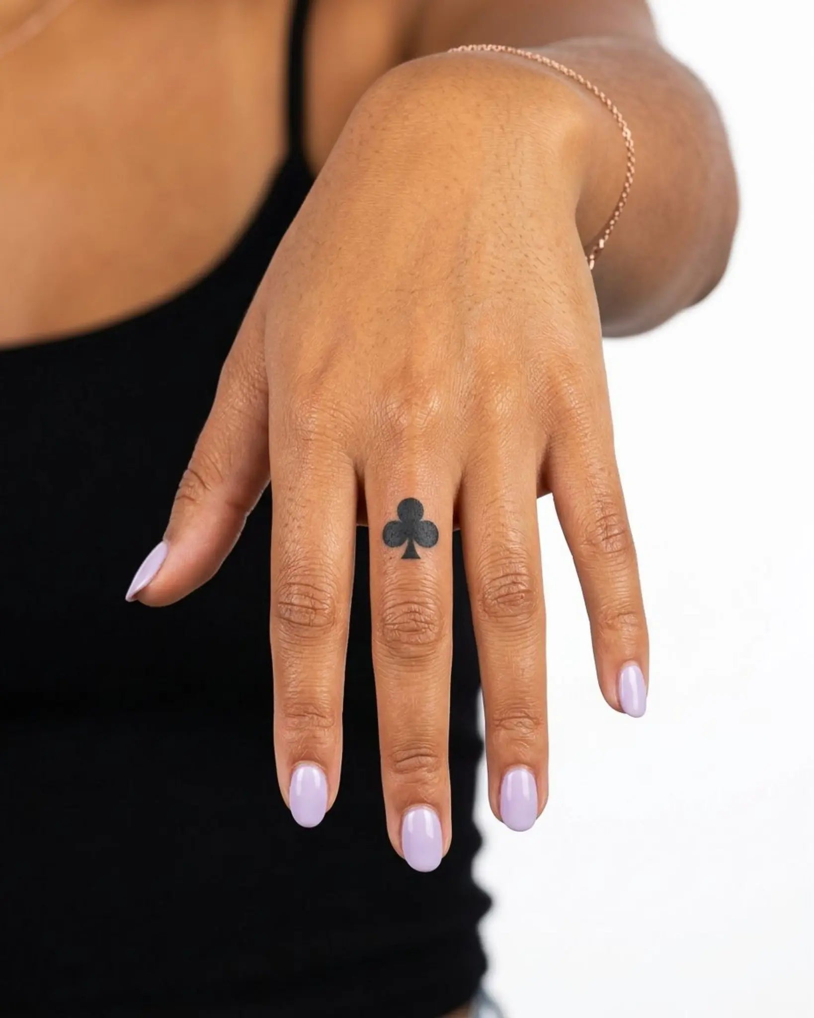 INKY Clubs semi-permanent tattoo applied on a woman – 0.5 x 0.5 in (1x1 cm) design, realistic ink look, lasts 10 days