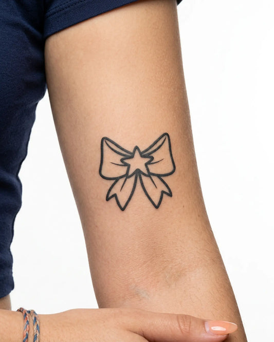 INKY Star Bow 2 semi-permanent tattoo applied on a woman – 3 x 3 in (7x7 cm) design, realistic ink look, lasts 10 days