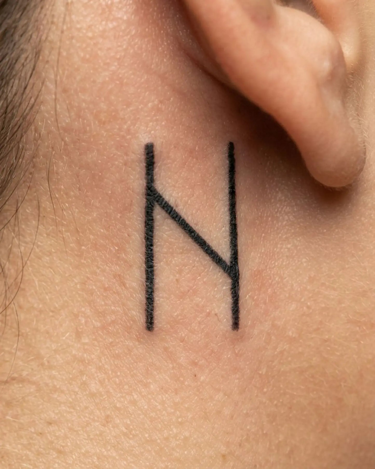 INKY Rune N semi-permanent tattoo applied on a woman – 0.5 x 0.5 in (1x1 cm) design, realistic ink look, lasts 10 days