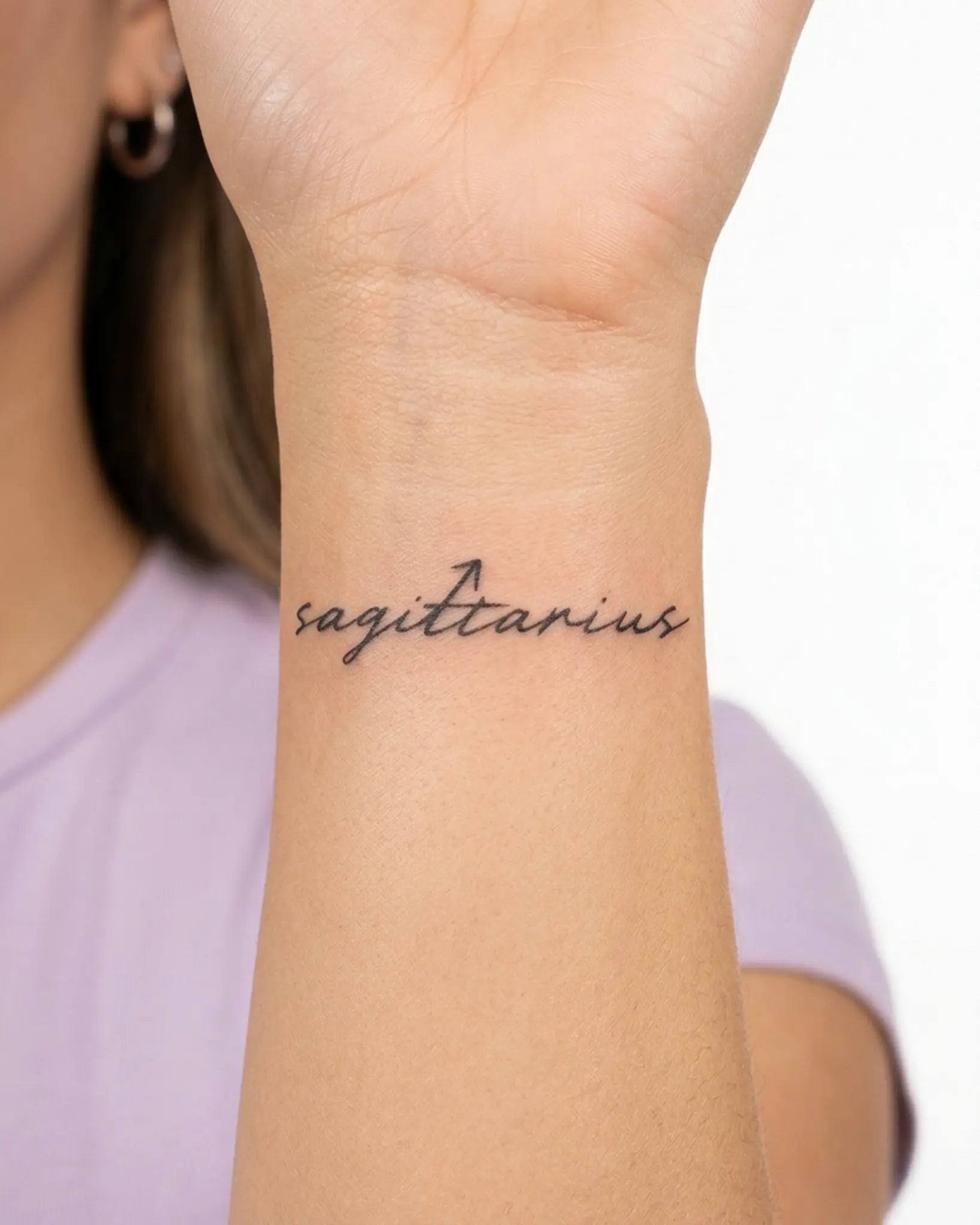INKY Sagittarius semi-permanent tattoo applied on a woman – 2 x 2 in (4x4 cm) design, realistic ink look, lasts 10 days