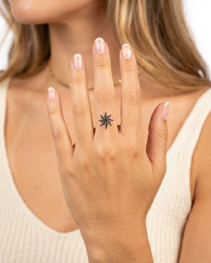 INKY Compass Rose semi-permanent tattoo applied on a woman – 0.5 x 0.5 in (1x1 cm) design, realistic ink look, lasts 10 days