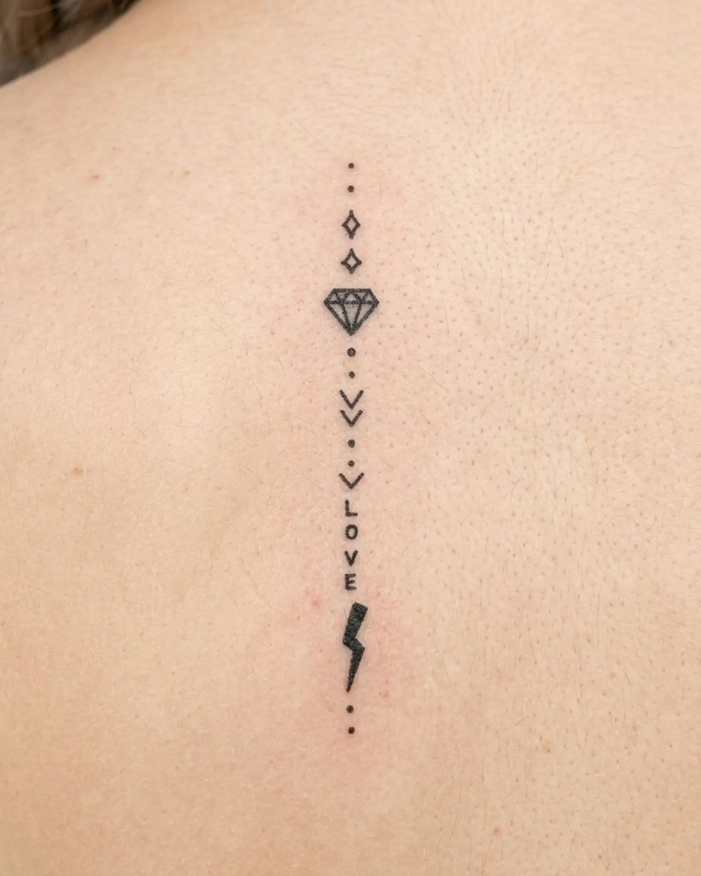 INKY Love Bolt semi-permanent tattoo applied on a woman – 2 x 4 in (6x10 cm) design, realistic ink look, lasts 10 days