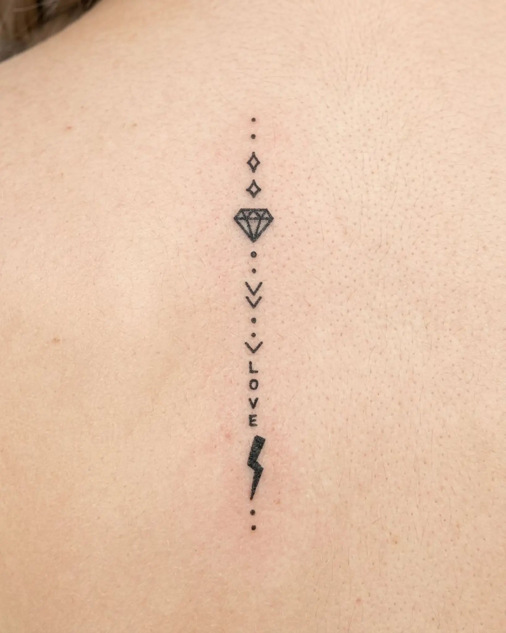 INKY Love Bolt semi-permanent tattoo applied on a woman – 2 x 4 in (6x10 cm) design, realistic ink look, lasts 10 days