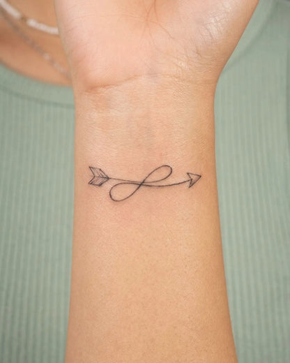 INKY Loop Arrow semi-permanent tattoo applied on a woman – 2 x 2 in (4x4 cm) design, realistic ink look, lasts 10 days